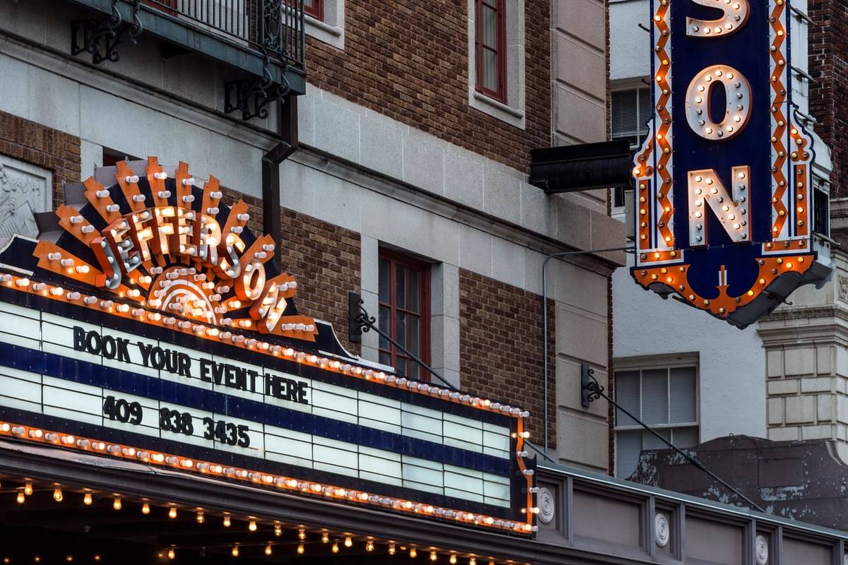 The lit marquee and blade sign of the Jefferson Theatre in downtown Beaumont