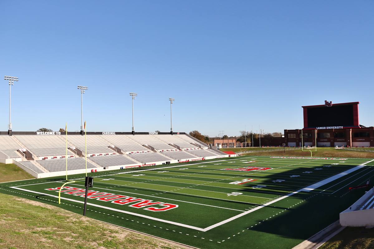 The football field and grandstands at Provost Umphrey Stadium at Lamar University, with Cardinals painted in the end zone