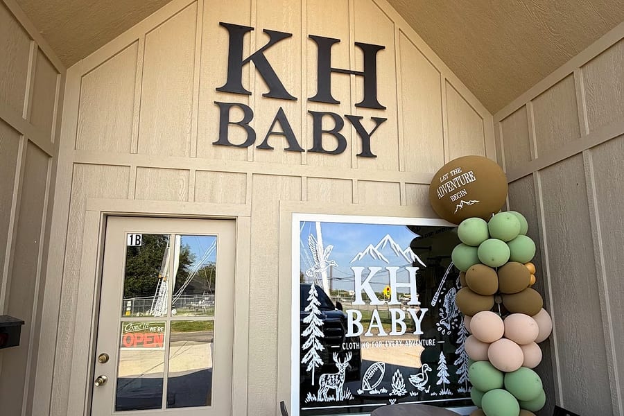 The KH Baby storefront at 2113 2nd St, Unit 1B, Port Neches, with KH BABY wall letters, an OPEN sign on the door and a balloon arch